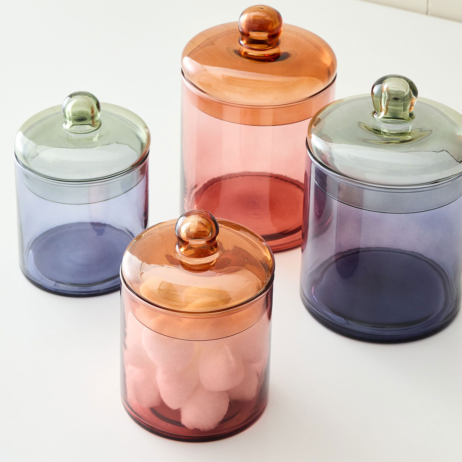 pink and blue colorblocked glass containers