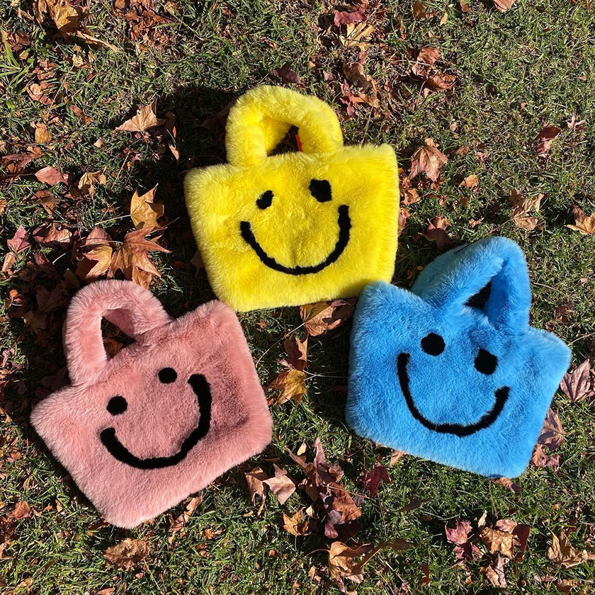 fluffy yellow, pink and blue smiley bag