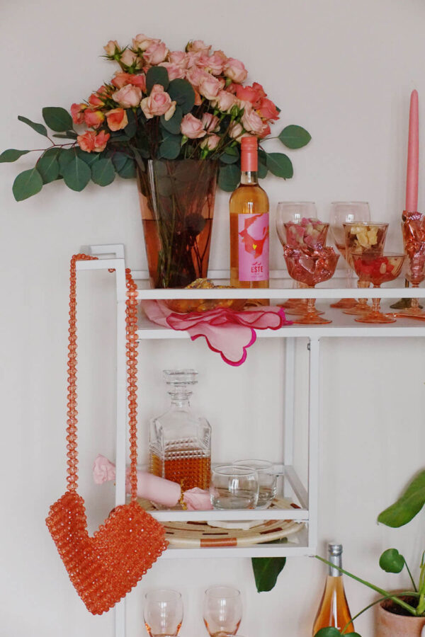 A Valentine's Day Candy and Bar Cart with wallflower's red bead bag