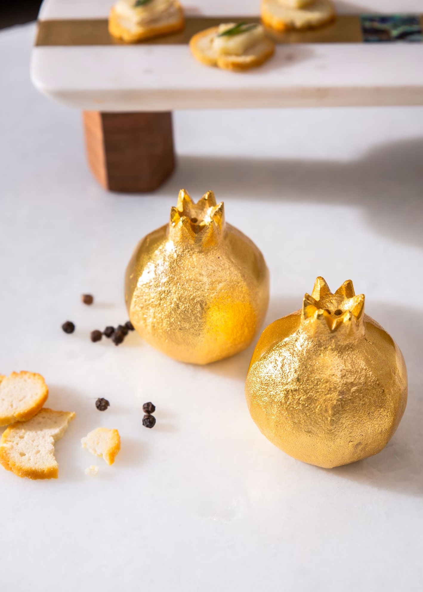 gold salt cellars in cute pomegranate shapes from Serein Decor on Etsy.