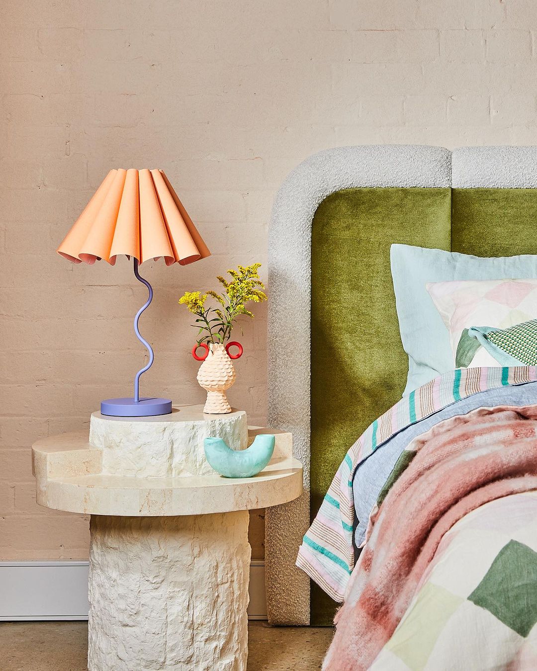 plush green headboard and peach lilac lamp from greenhouse interiors