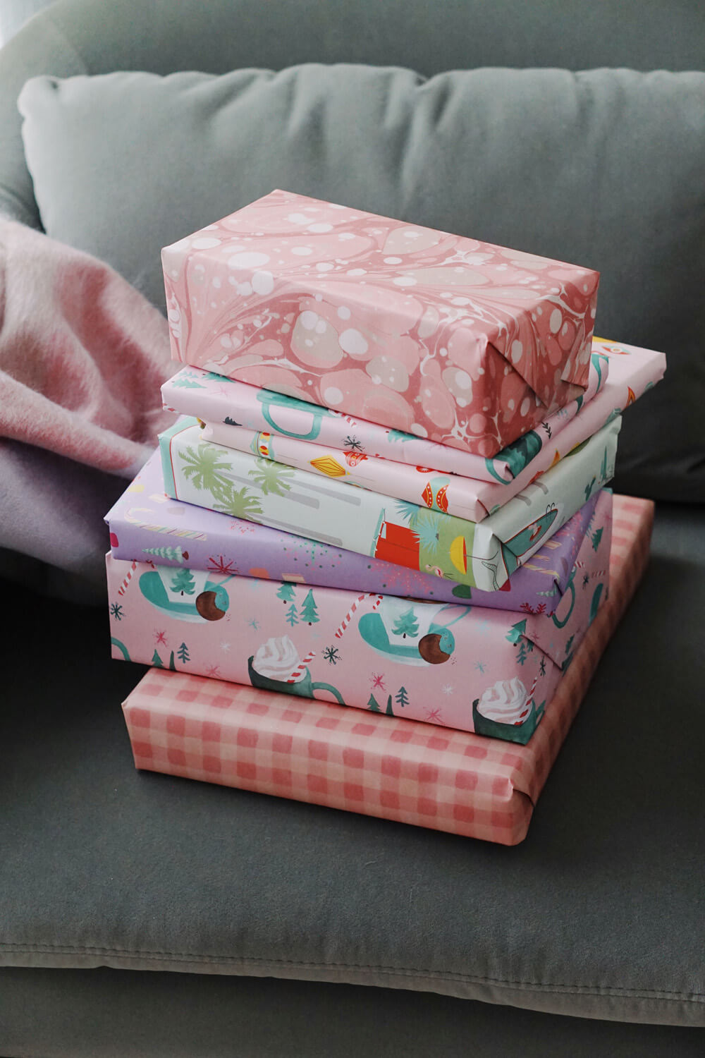 present stack with pastel pink and purple wrapping paper for christmas
