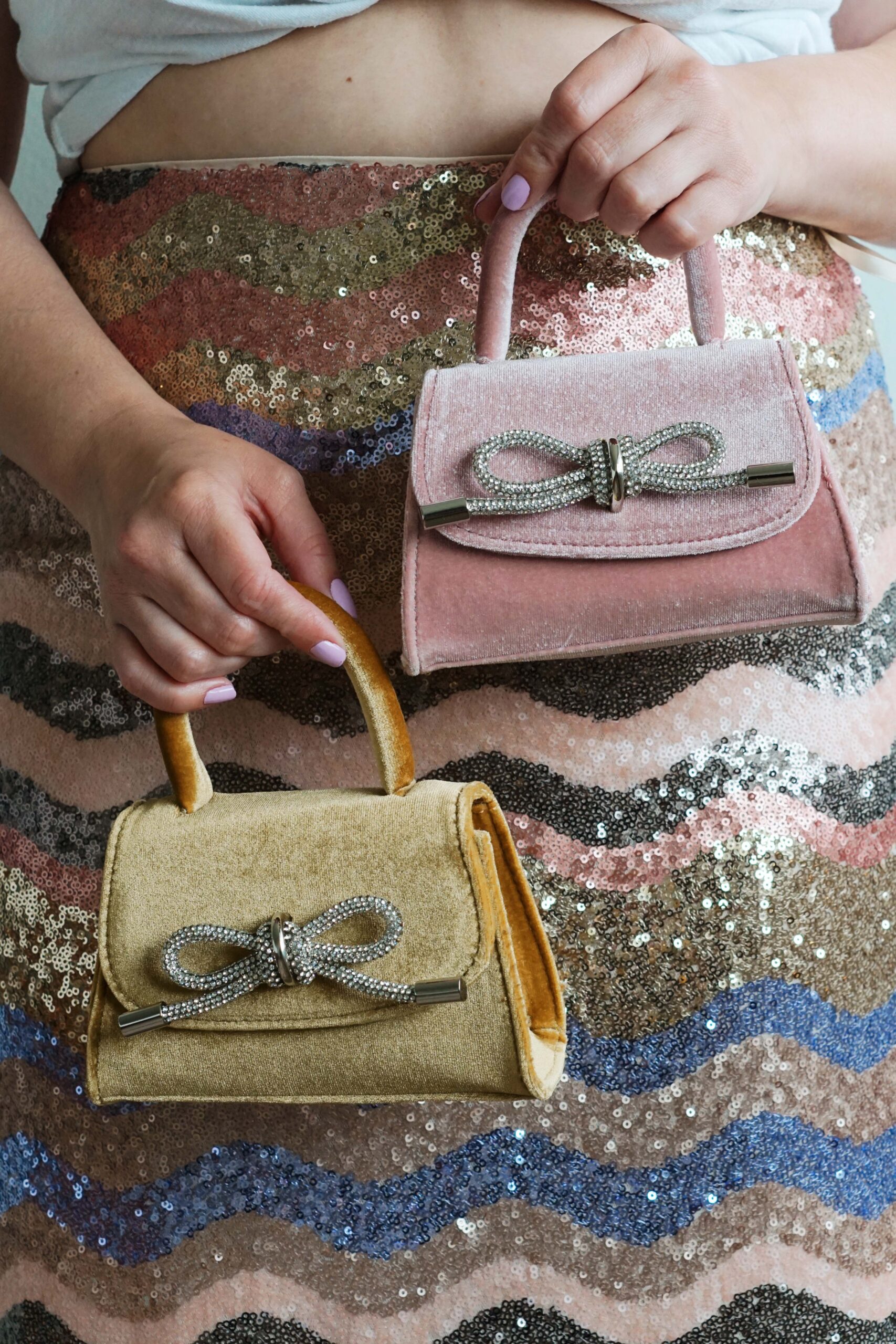 pink and yellow velvet bags with silver rhinestone bows